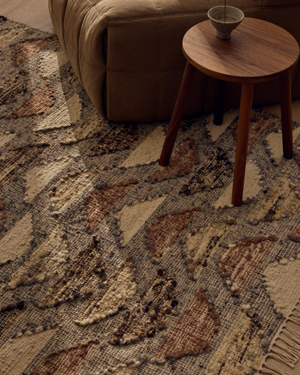 Close view of the Tribe Home Orissa wool and jute rug's half-moon pattern beside a side table