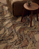 Close view of the Tribe Home Orissa wool and jute rug's half-moon pattern beside a side table