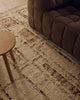 Close view of the Tribe Home Rama wool and jute rug in Cinnamon beside a sofa and side table