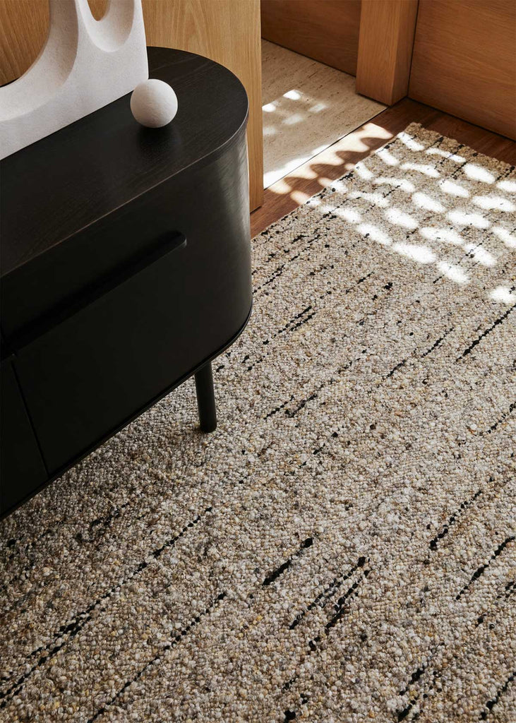 The Tribe Home nz Flint wool rug shown close up under a sideboard