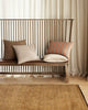 A modern bench-seat featuring the striped vinnie cushion by Weave Home nz in colour 'terracotta'