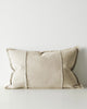 Beige lumbar cushion with textured edges on a light gray background