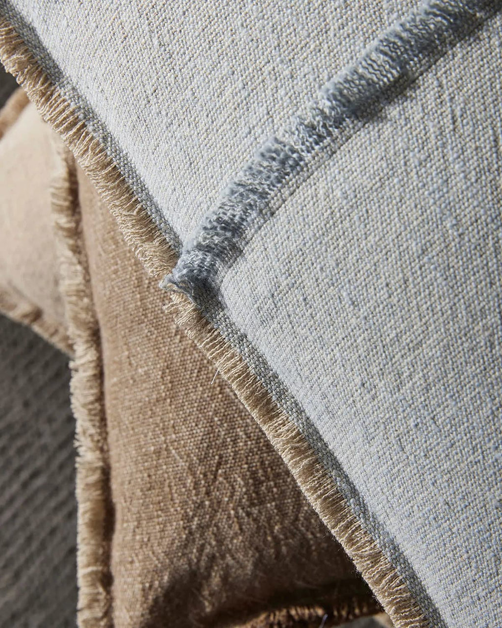 Close-up of textured cushions with a neutral color palette