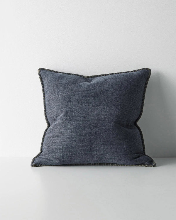 Blue textured cushion with feature stitching on a white background