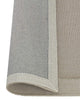 The Weave Home NZ wool rug 'Cassio' with edge rolled up to reveal backing