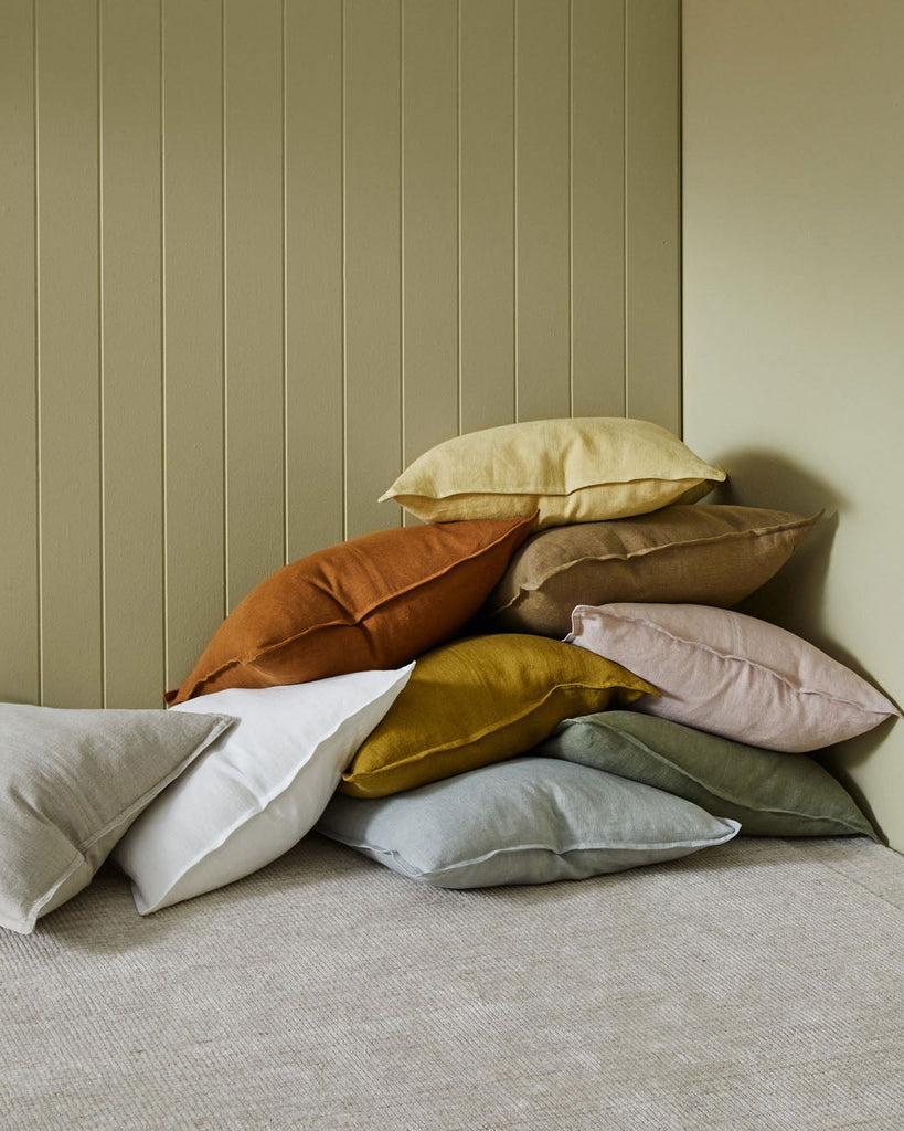 Weave Home NZ Pile of European Linen Cushions in plain colours, they feature a panel detail