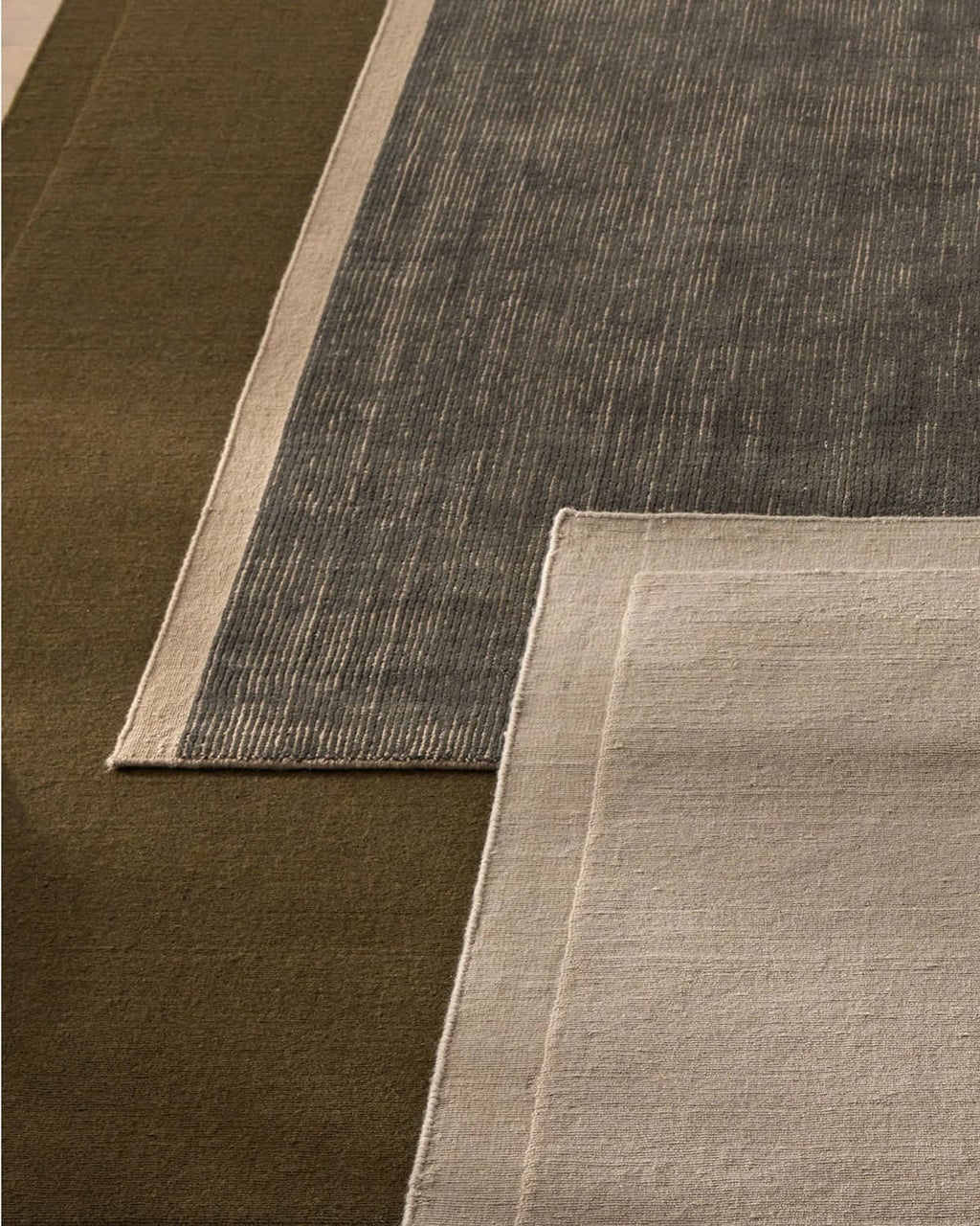 Weave Home NZ wool Close-up of three different textured rugs in brown, navy, and sand
