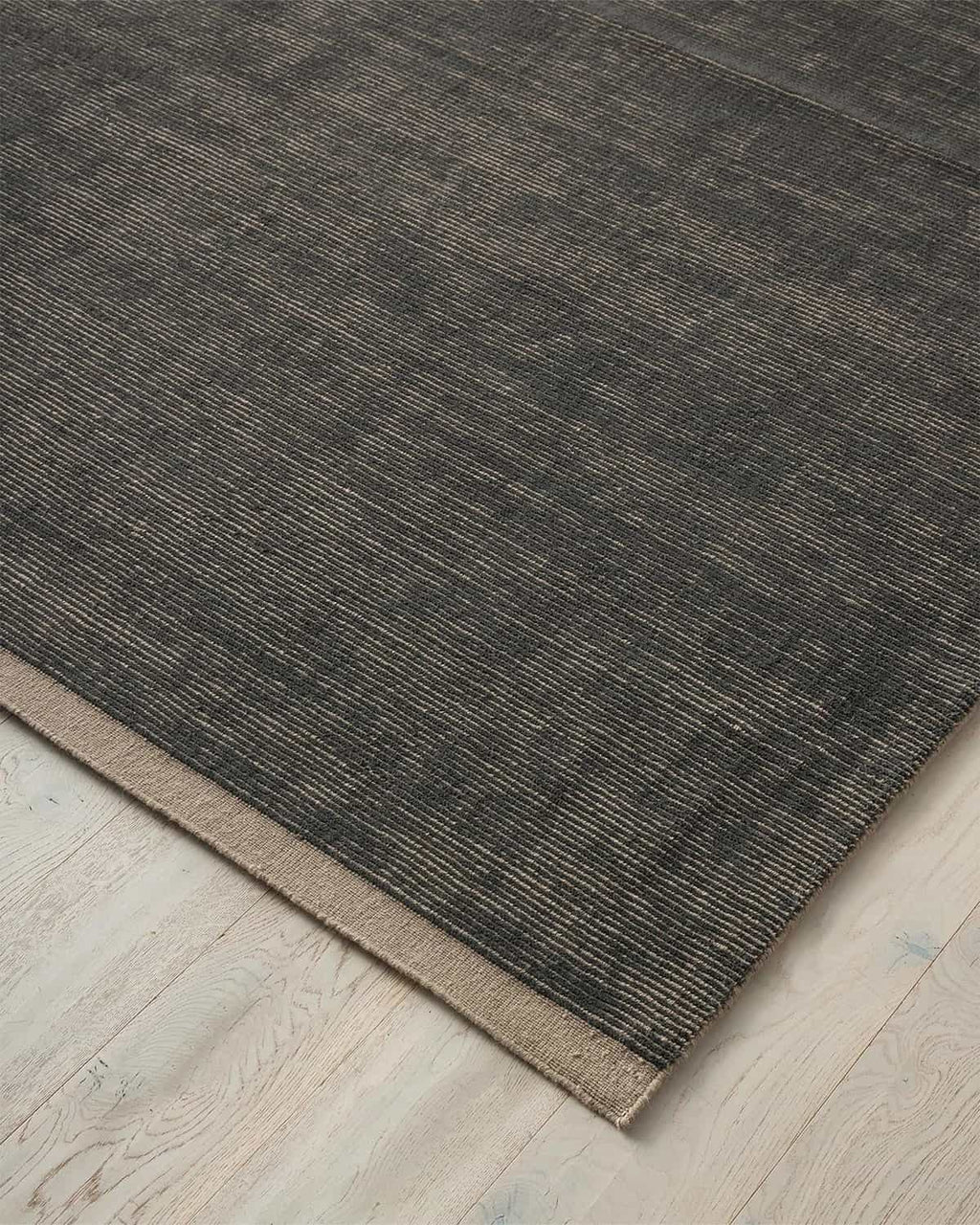 Weave Home NZ wool dark navy rug on a light wooden floor