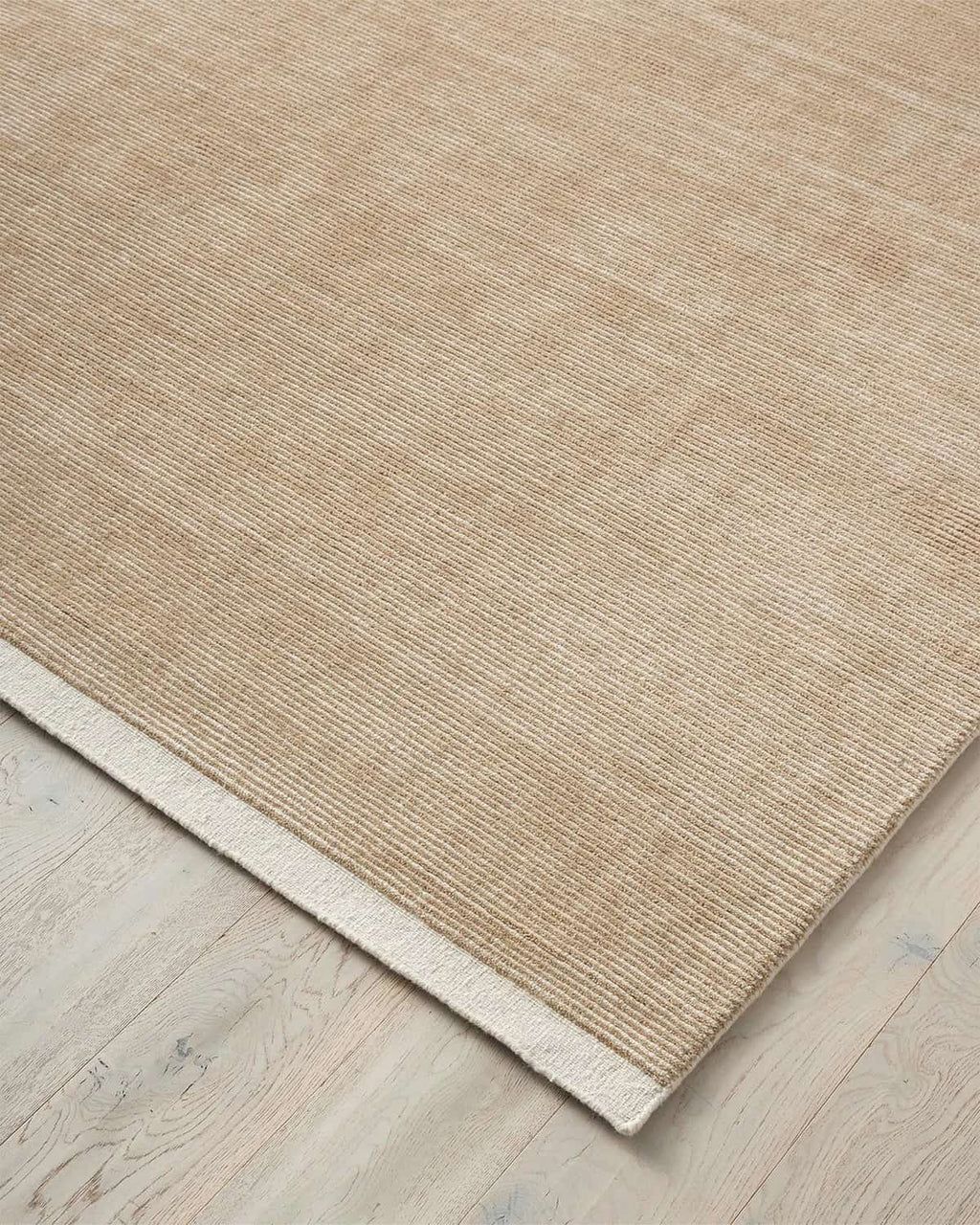 Weave Home NZ wool Beige rug on a wooden floor