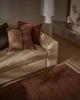 Weave Home NZ wool amber rug with sofa in a living room setting