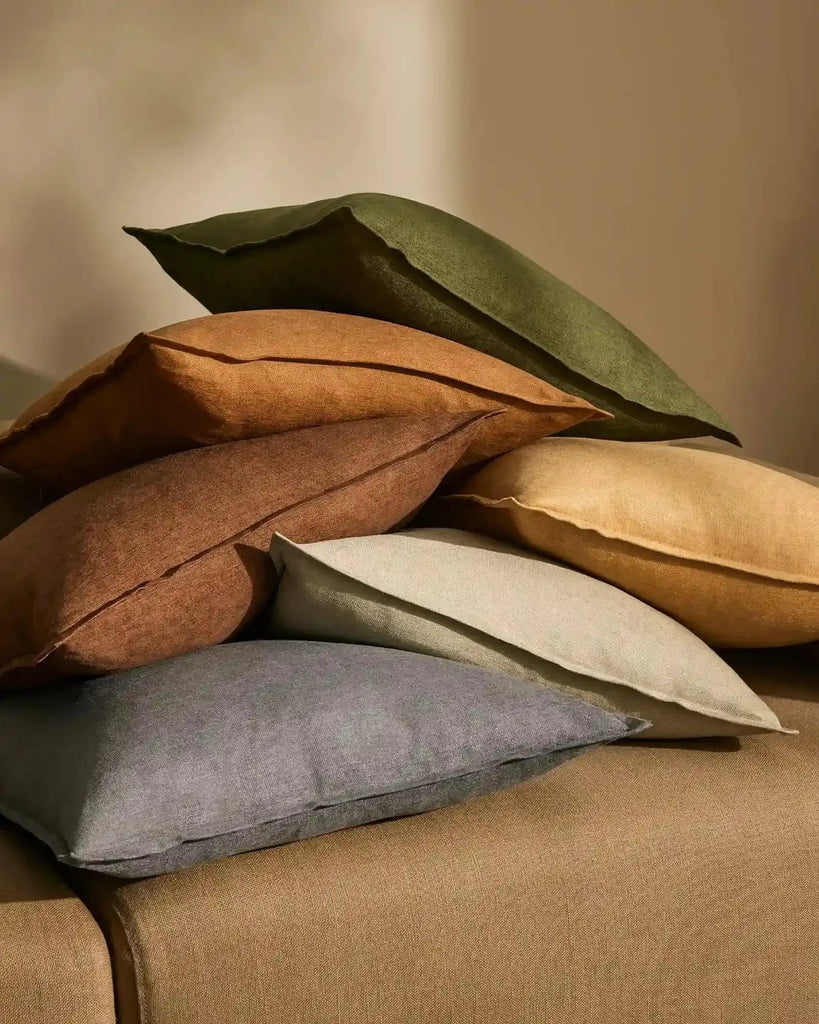 Stack of luxurious, earthy toned,Weave cushions fromt he Fiore range, a linen chenille blend