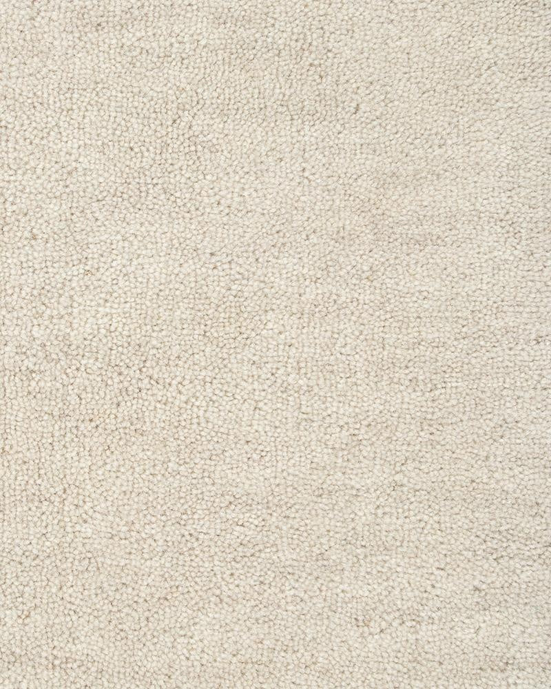 The Sandringham  creamy white 'merino' 100% wool floor rug seen close up highlighting the wool pile and soft natural white colour.