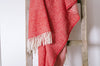 100% wool NZ throw blanket by Ruanui Station, in vibrant 'Rakaia red', shown draped