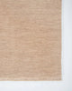 Corner of the Baya Sandringham wool rug in blush pink 'Cameo' colour, with small tasseled edge, from above