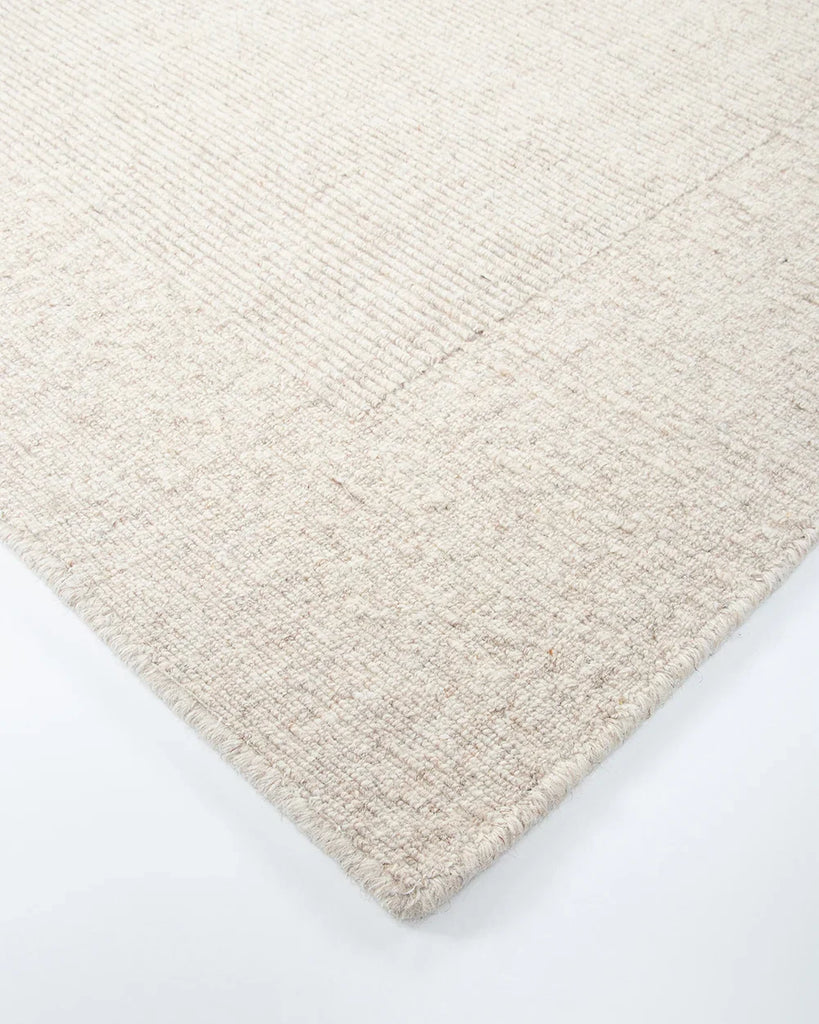 Close up corner shot of the Baya wool rug 'Vermont' in neutral colour 'Sand