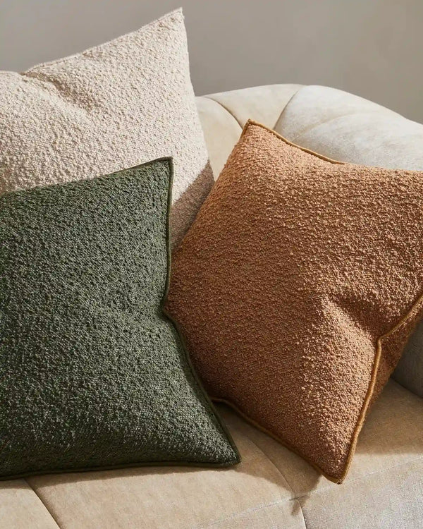 Weave nz cushions with a boucle texture, decorating a couch