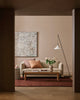 Baya Bastion NZ wool floor rug in Claret, styled under a timber coffee table in a living room, seen through a doorway.