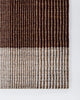 Baya Bedrock Indoor and Outdoor Floor Rug in Claret, flat-lay corner detail on a white background showing the dark chocolate-brown striped field meeting the paler oatmeal striped border and edge binding.