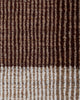 Baya Bedrock Indoor and Outdoor Floor Rug in Claret, close-up texture detail of the flatweave showing dark chocolate-brown ribbed stripes meeting the paler oatmeal striped border.
