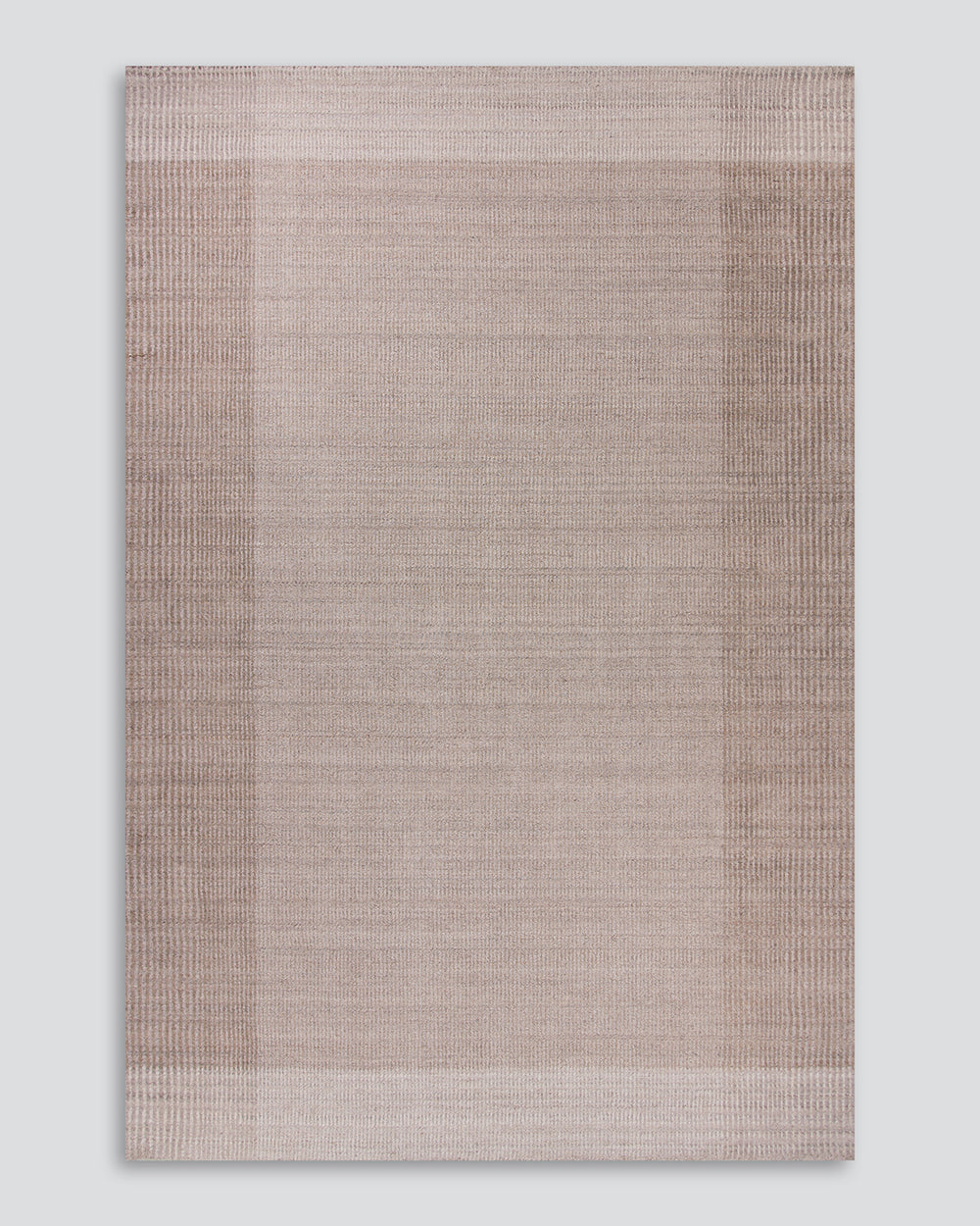 Baya Bedrock Indoor and Outdoor Floor Rug in Sand, full flat-lay product shot on a plain grey background showing the taupe field framed by a darker toned wide border and pale outer stripe.