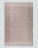 Baya Bedrock Indoor and Outdoor Floor Rug in Sand, full flat-lay product shot on a plain grey background showing the taupe field framed by a darker toned wide border and pale outer stripe.