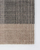 Baya Bedrock Indoor and Outdoor Floor Rug in Zinc, flat-lay corner detail on a white background showing the charcoal striped field meeting the sand-toned striped border and edge binding.