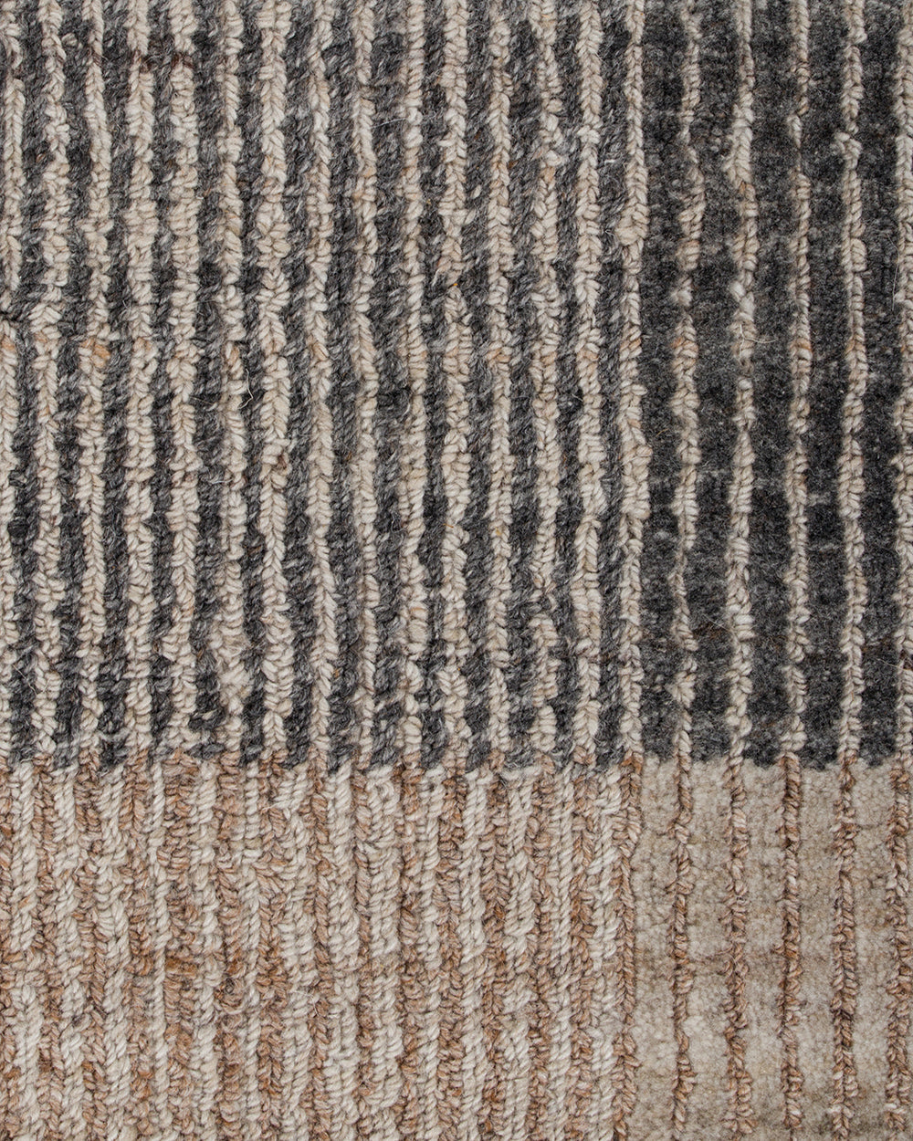 Baya Bedrock Indoor and Outdoor Floor Rug in Zinc, close-up texture detail of the flatweave showing the charcoal-grey ribbed stripes meeting the paler sand striped border.