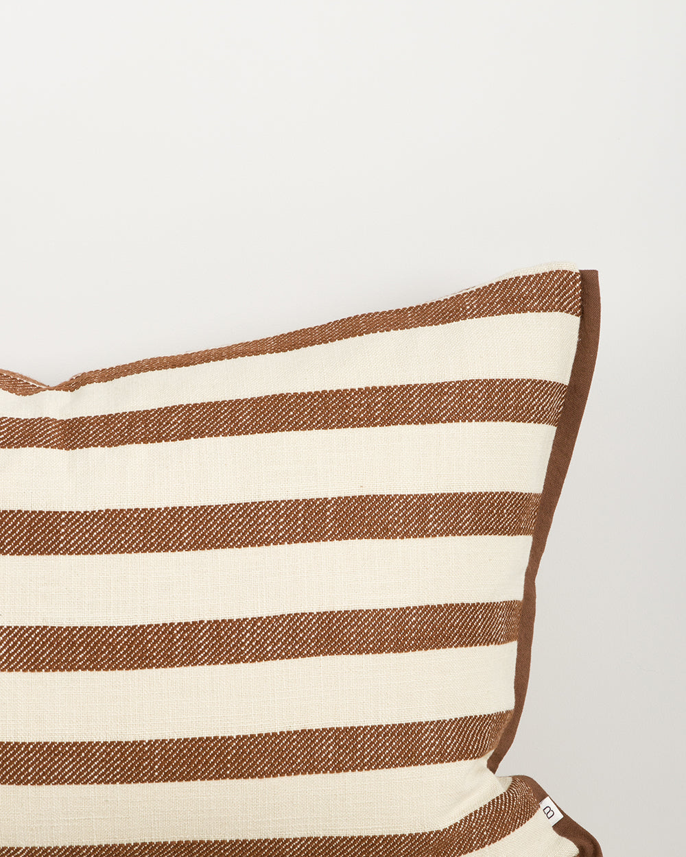 Baya Calden cotton lumbar cushion in Chestnut, close view of the flanged edge and jacquard stripe