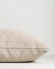 Side profile of the Baya Dune outdoor cushion in Almond, lying flat, showing the piped seam edge
