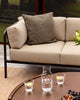 Baya Dune outdoor cushion in Mangrove styled on the corner of an outdoor sofa