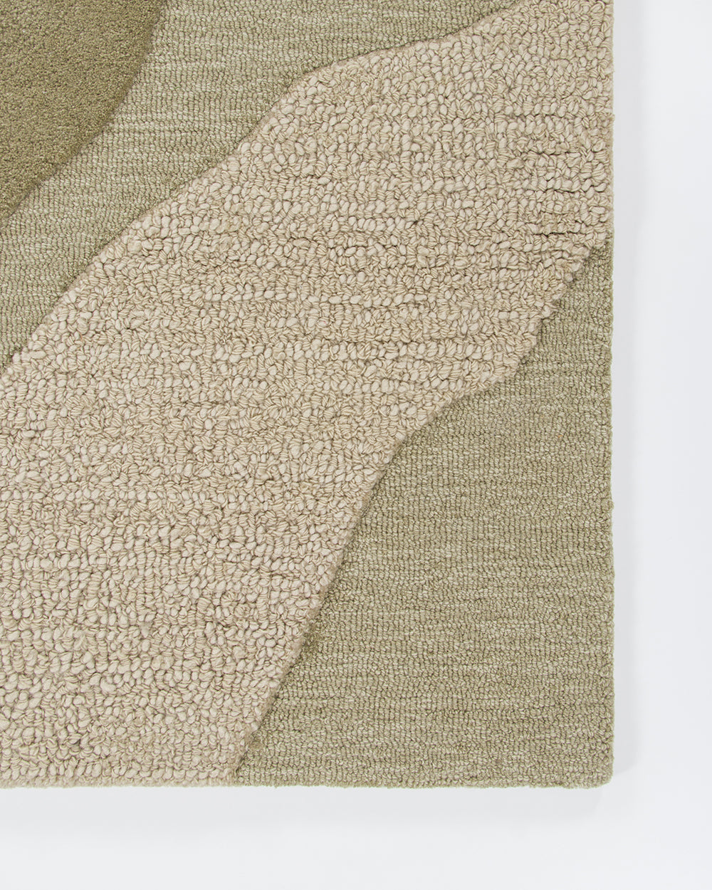 Baya Edgewater NZ wool floor rug in Pistachio, rectangle, close view of a corner showing the wave pattern in cut and looped pile.