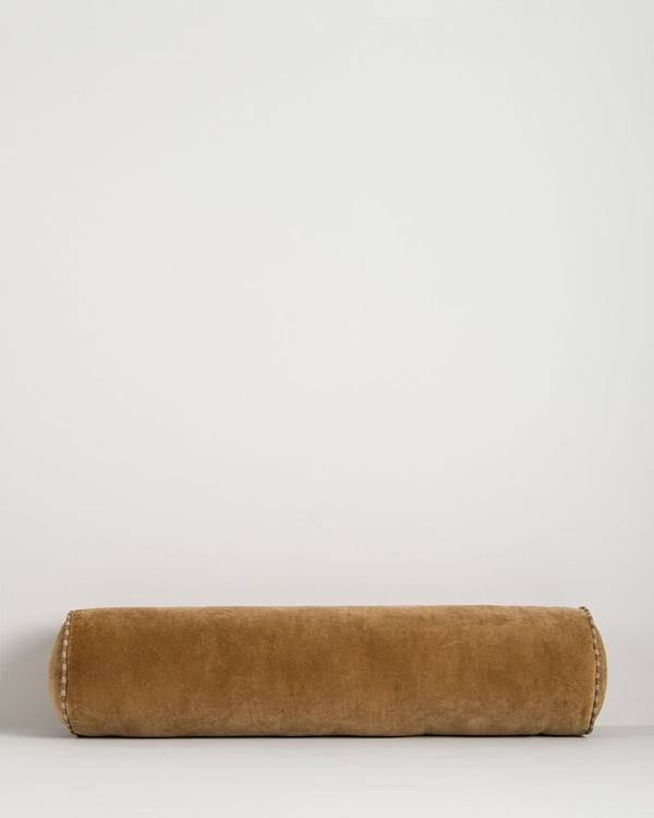 Baya Elliot cotton velvet bolster cushion in Butterscotch on a plain background