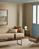 Baya Fairmont NZ Wool Floor Rug in Ash, under a sofa styled with a striped and a brown cushion
