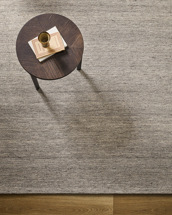 Baya Fairmont NZ Wool Floor Rug in Ash, overhead view beside a round side table with a book and vase