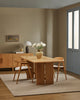 Baya Fairmont NZ Wool Floor Rug in Ash, under an oak dining table with a sideboard and vase of flowers