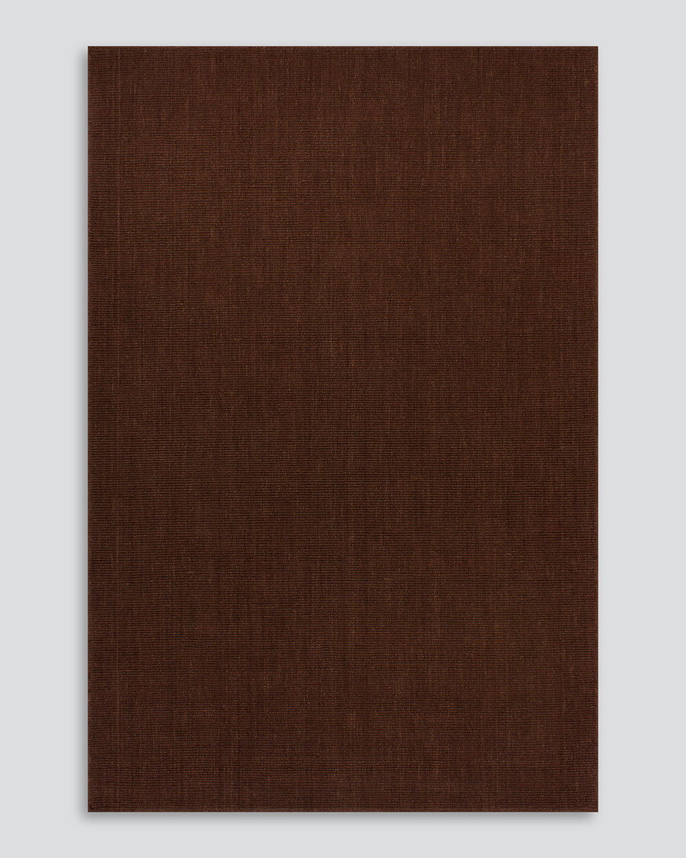 Full-length view of the Baya Linden Floor Rug in Brick, a handwoven flatweave rug in an earthy, faded red-brown wool.