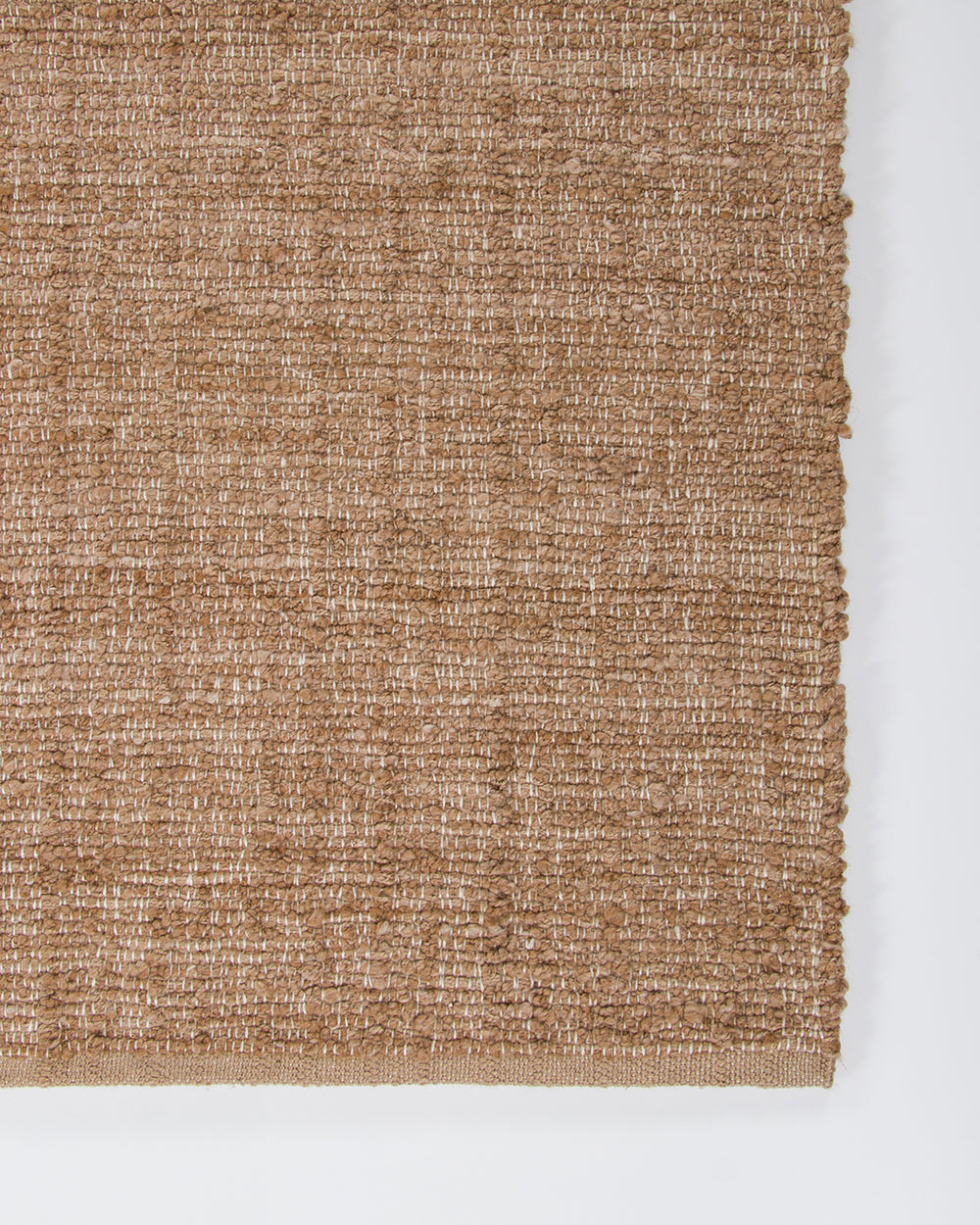 Baya Ormond outdoor rug in Biscotti, close view of a corner showing the flat-woven texture and edge.