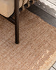 Baya Ormond outdoor rug in Biscotti, styled on a timber deck beneath an outdoor chair.