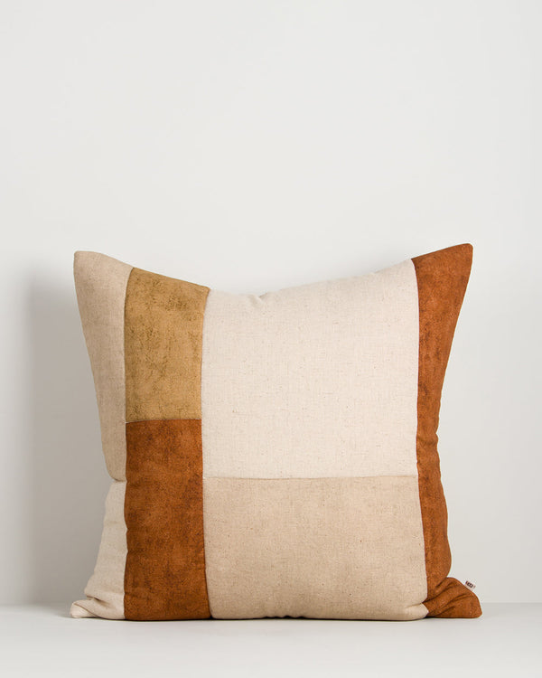 Baya Piazza Cushion in Multi on a plain background, showing the colour-block panels in rust, ochre and natural.