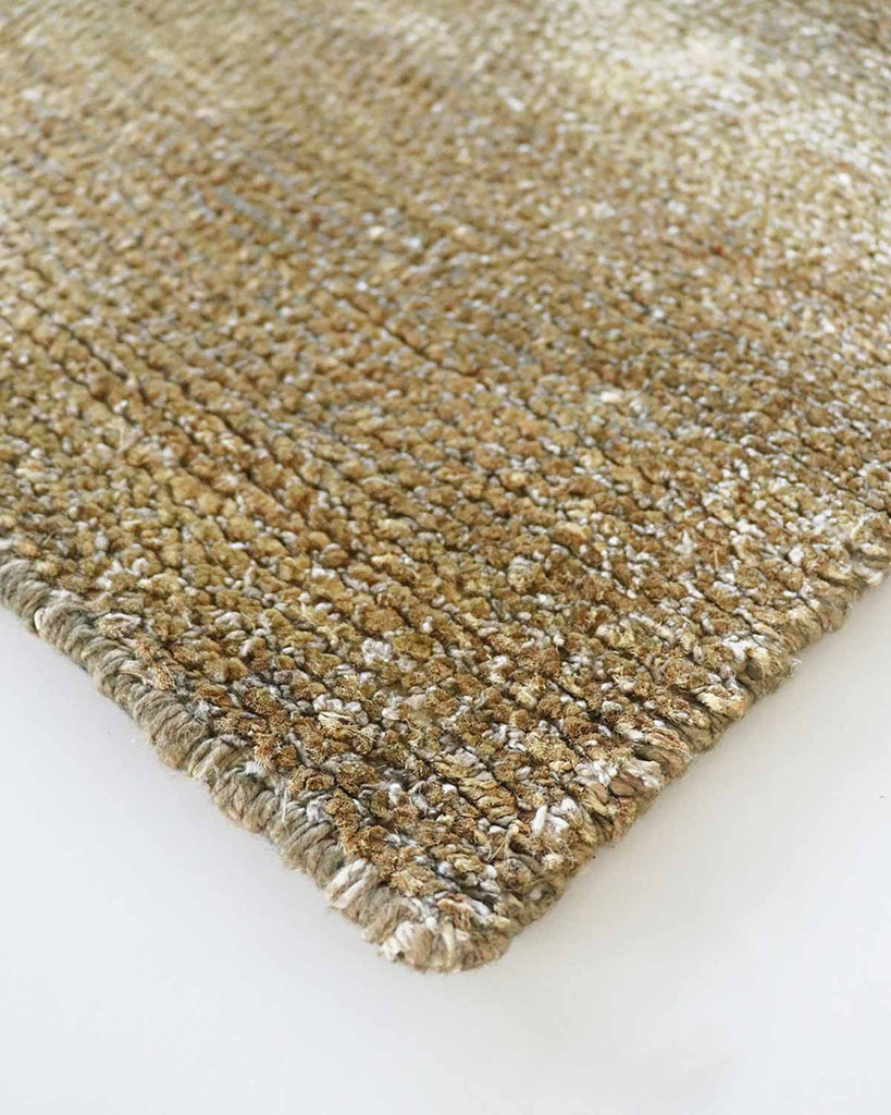 Close-up of corner of Baya NZ Anchorage rug with warm brown tones. 