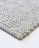 Close up view of the corner of a Baya NZ rug in cool toned weave.