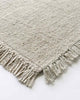 A detailed view of the corner of the Ulster rug by Baya NZ, showing off its fringed edges. 