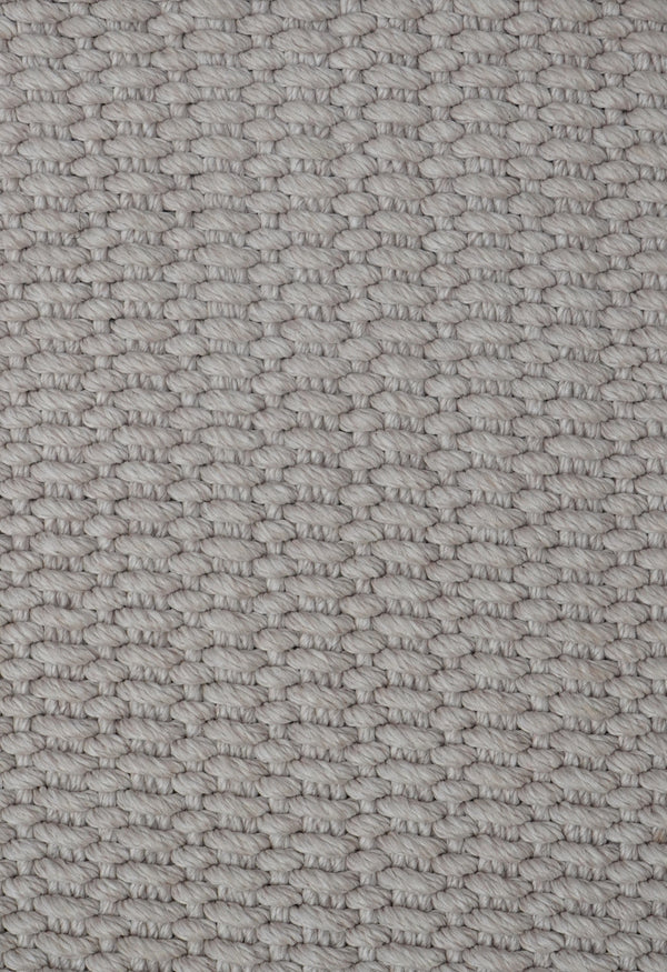Close-up of the By Carmont Bisque rug's PET weave texture in Cameo
