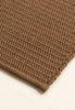 By Carmont Bisque floor rug in Natural, close-up of the textured weave and bound edge
