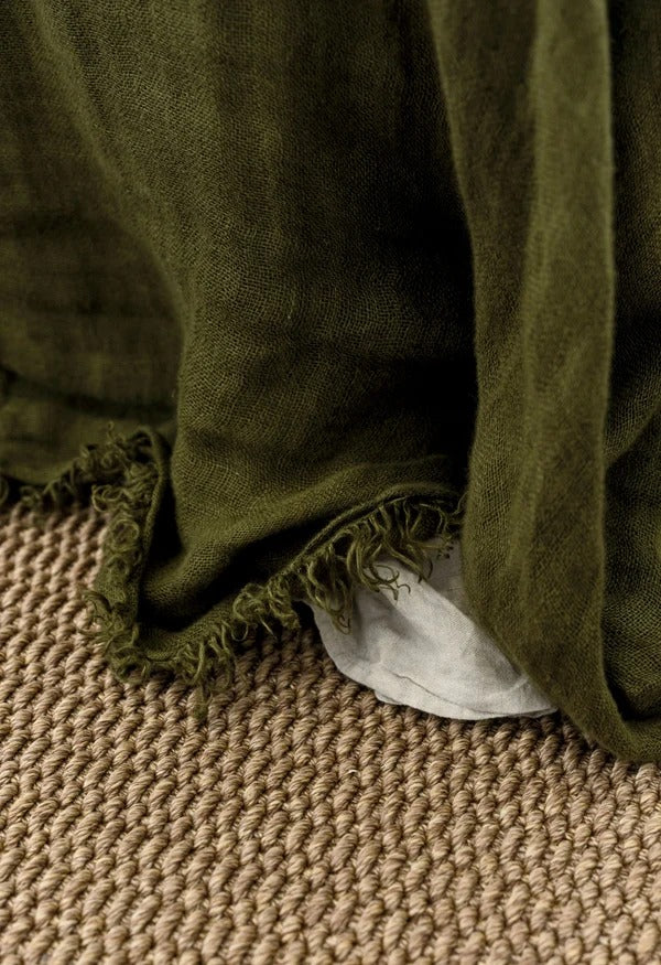 By Carmont Bisque floor rug in Natural styled with a draped throw