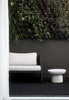 By Carmont Bisque floor rug in Sable styled on a covered outdoor patio