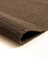 By Carmont Bisque floor rug in Topaz, close-up of the folded corner showing the woven texture and finished edge
