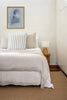 By Carmont Aman floor rug in Natural, styled in a bedroom setting