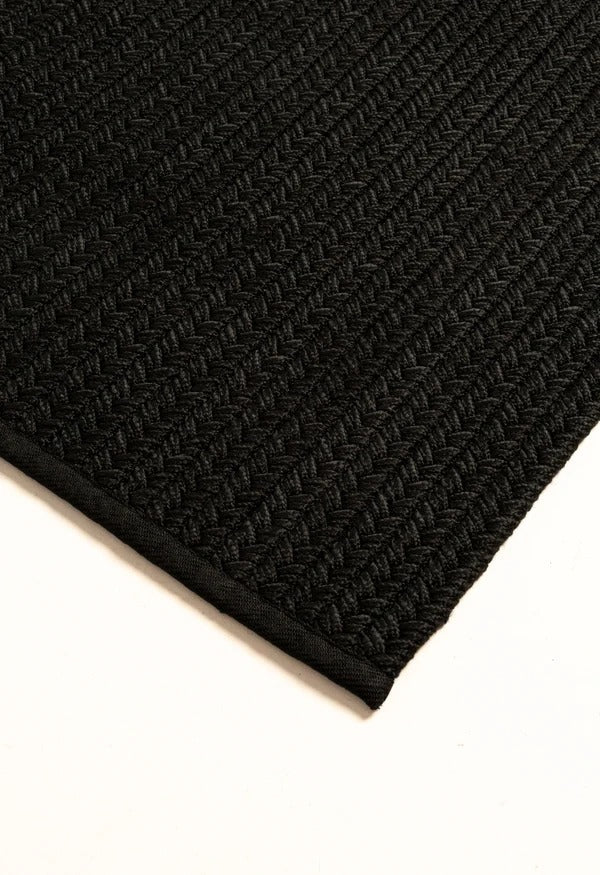 By Carmont Aman Floor Rug in Sable, corner detail showing the edge binding