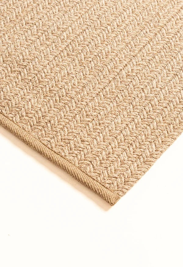 By Carmont Aman floor rug in Sandstone, corner detail showing the edge binding